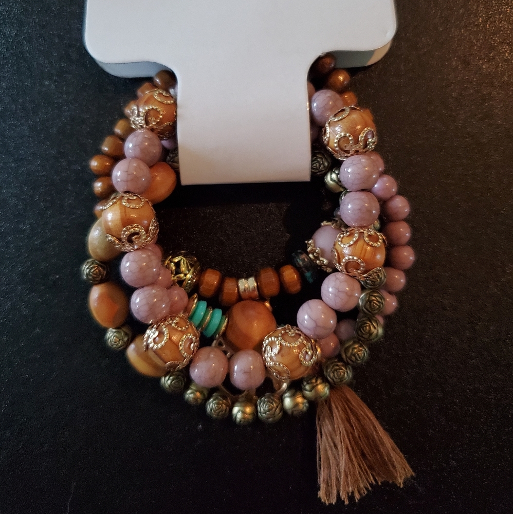 Set of 4 bracelets with tree ornament and tassel.